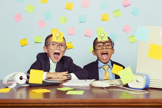 Two Young Businessmen at Desk Covered with Sticky Notes